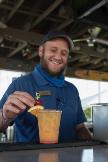 Tiki Bartender Danny Longley finishes making a rum runner