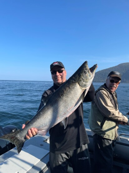 Cobb catching a King Salmon of the coast of Alaska with clients