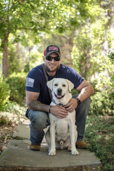 Joshua and his service dog, Champ