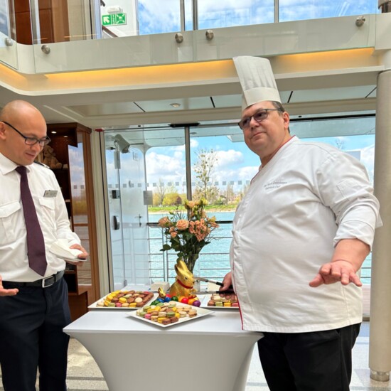 Chef Karl Heinz Zwanzleitner and Maitre d’ Gil Ocampo greet guests returning from a tour of Strasbourg with trays of French macarons.