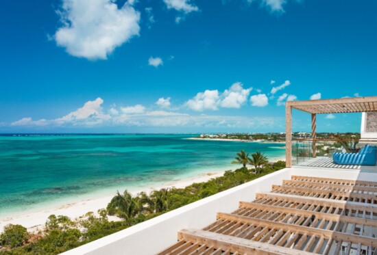Guests enjoy exclusive access to a premier beachfront spanning 100 feet and a shaded beach deck.