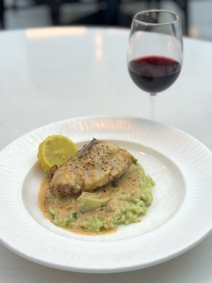 Pan-seared sea bass with shaved truffle risotto from Versailles.
