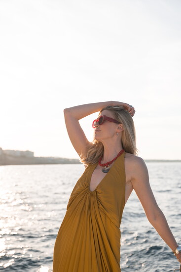 Einaudi thrifted the dress pictured at Blue Bird Circle and the necklace from The Guild Shop. 