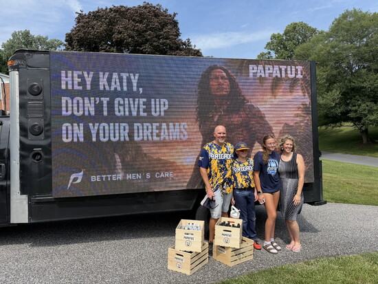 Katy Napier and her family in front of sign. Photo courtesy of Katy Napier.