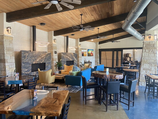 The tasting room is elegantly furnished with tables sourced from local pecan trees. 
