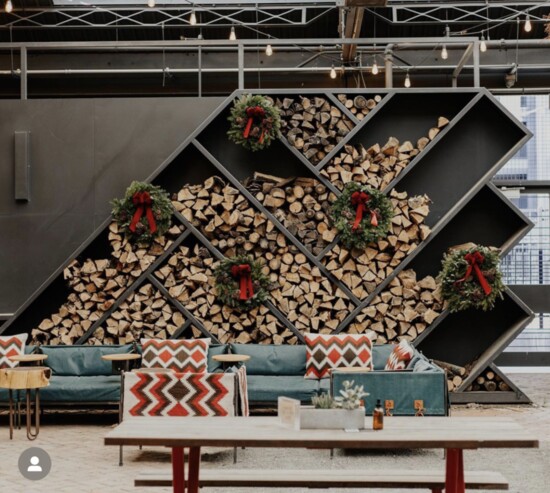 Firewood and wreaths form an unusual but elegant holiday backdrop.