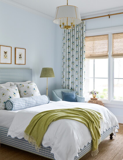 A sisal rug and sea grass window shades add natural elements to this bedroom designed by Houston interior designer Katie Davis.