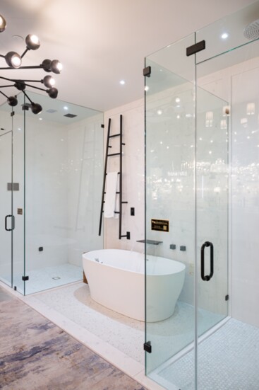 Clean lines, a steam shower, lighted tub and heated towel rack are all found in this functional bathroom display.