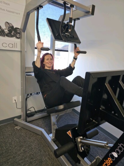 Coach Hailey demonstrating the leg press