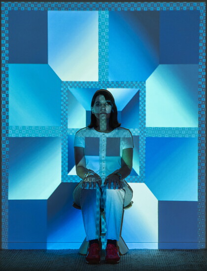 Rachel becomes the art she creates as an image is projected onto a white wall in her studio.  Photography by: Jimmy ienner Jr.