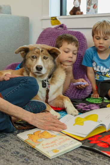 Gracie paws-itively enjoys storytime moments with children during PAWS for Reading at the Severance Library.