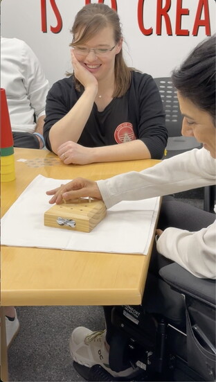 Coulston practicing hand mobility using the ARC-EX System
