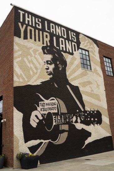 Woody Guthrie mural on the side of the Woody Guthrie Center in Tulsa's Arts District.