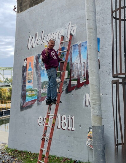 Mark DeCracker working on a mural