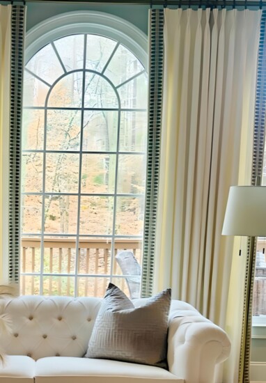 The white sofa and window treatment provides a warm and neutral foundation for any room.