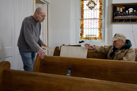Bob Turrel (standing) and John Briggs are among the volunteers with Friends of Sacred Structures.