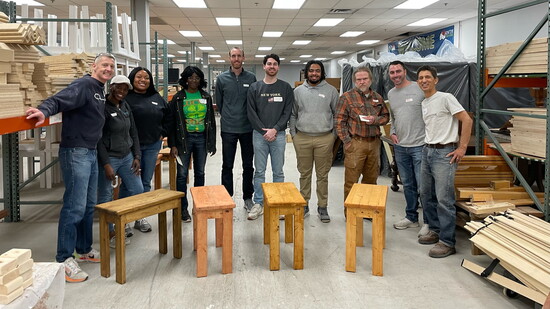Nick Francis (far right) crafts furniture from scrap wood with a team of volunteers.