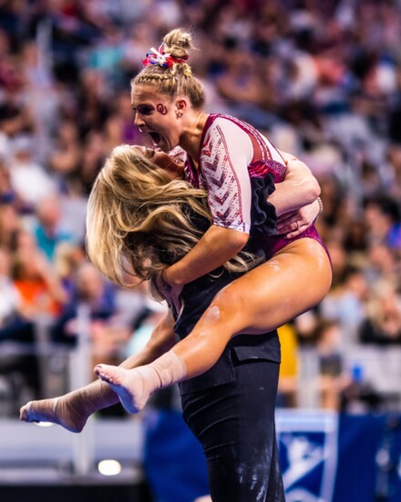 Coach K.J. Kindler and Ragan Smith celebrate after Ragan’s routine on the balance beam, the last routine in the final event, guaranteed another title for the So