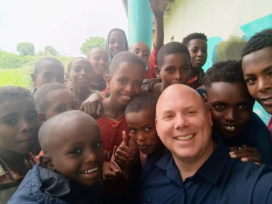 Keith Sharp, CFO, with students in Ethiopia
