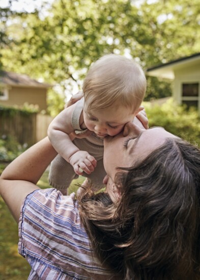 New mom Claire Spollen with her baby Sully in the backyard of photographer Jen Causey