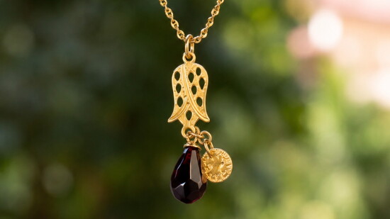 A tribute to Middle Eastern artistry, the Pomegranate & Hand Necklace pairs two ancient symbols—fertility and protection—into a timeless emblem of abundance.