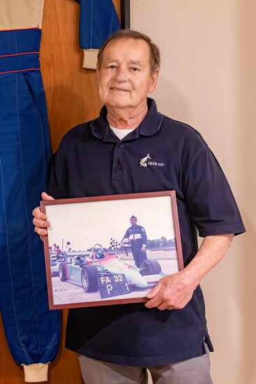 Barry holds a photo of himself following a big win, first place in an FA race.