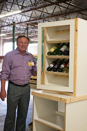 Jeff Reasor, CEO of Reasor' s Grocery chain shows how some of the wines being carried will look in the new wine displays being built specifically for Reasors