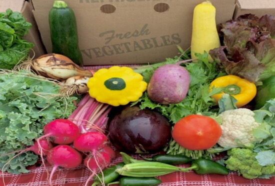 Farm-fresh organic produce delivered in a half-bushel box.