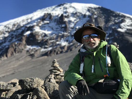 On his wrist, Mike wears a handmade bracelet with the inscription “Babu,” or grandpa, in Swahili, a loving nickname from a former mountain guide.
