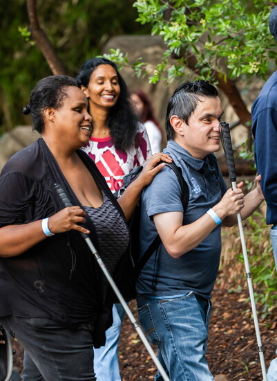 Carlos Blanco walks with friends at the White Cane Day Walk 2025