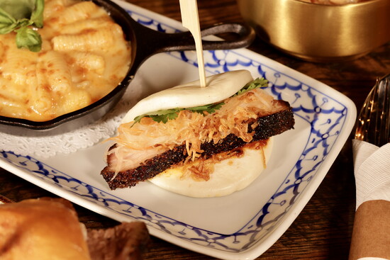 A marriage of cuisines at Charm Taphouse: Seen here, their red curry mac and cheese and a smoked pork belly bao bun. 