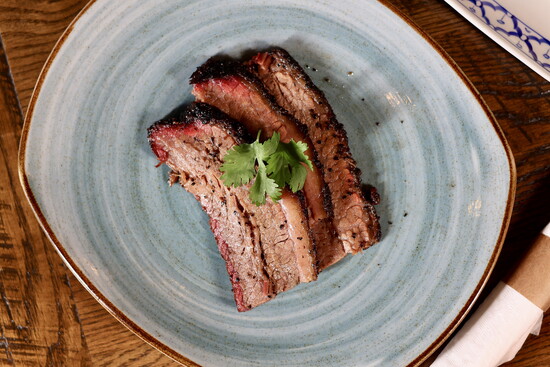 The brisket at Charm Taphouse is smoked in-house over post oak.