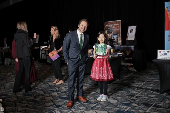 Seen here with Head of School Dr. Stephen Popp (left), Adele Cheng was a "Visiting Author" at the event and is also a current John Cooper student.