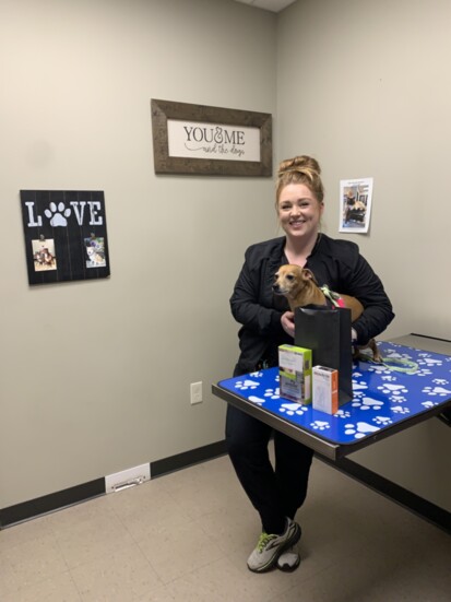 Vet tech Carrington Trace Loop with Cooper and his flea, tick, and heartworm medications.