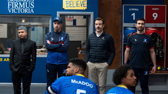 "Ted Lasso" scene featuring Hunt, known for portraying Coach Willis Beard, with co‑stars Nick Mohammed, Jason Sudeikis and Brett Goldstein. (Courtesy of Apple)