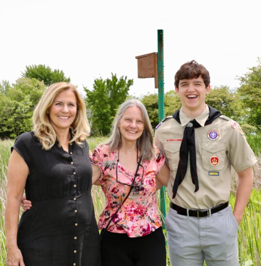 Founders Pam Self, Shari Gullo and Eagle Scout Kyle Wanca in front of a birdhouse at the groundbreaking ceremony of the Phoebe Snetsinger Garden.