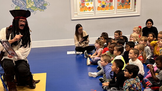 Tom reading to students