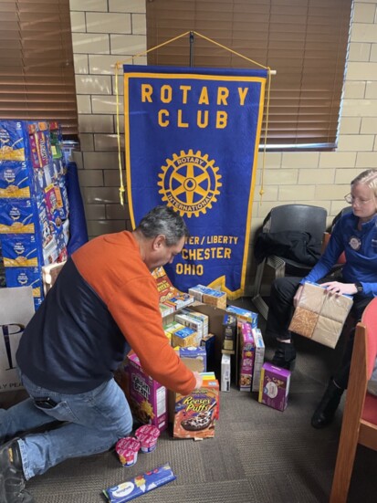 Constructing canned food items into a display for Sleep in Heavenly Peace.