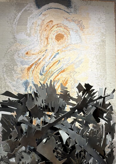 An Albert Paley sculpture with a Paul Reynard artwork-inspired rug behind it