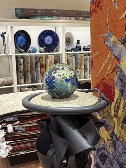 A Joshua Simpson "Mega Planet" on a sculptured plant stand by Albert Paley