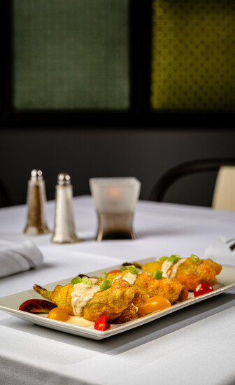 Zucchini Blossom: squash blossoms filled with ricotta and mozzarella, drizzled with a madeira wine cream sauce, grape tomatoes