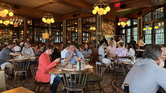 Warm lighting and honey-toned wood create a cozy, inviting atmosphere for dinner.