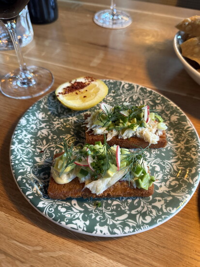 Delicate peekytoe crab with dill on crisp toast offers a light, flavorful start to the meal.