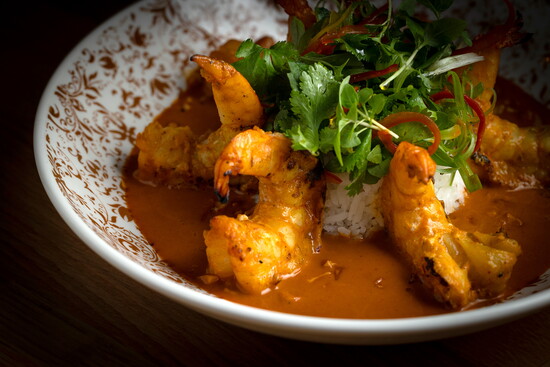 Aromatic red curry prawns showcase vibrant flavors in every bite. (Photo credit Ballyhoo Hospitality)