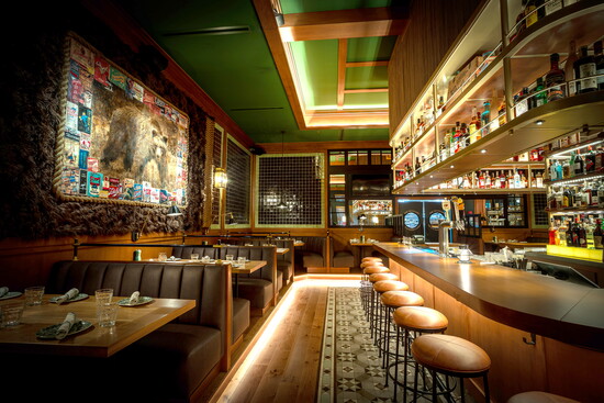 The bar’s warm lighting and polished wood invite guests to linger over craft cocktails and conversation. (Photo credit Ballyhoo Hospitality)