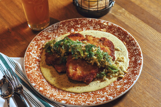 A perfectly crispy pork schnitzel served with flavorful spätzle and tarragon-mustard sauce. (Photo credit Ballyhoo Hospitality)