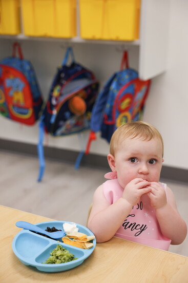 The toddler room enjoying a delicious lunch together.