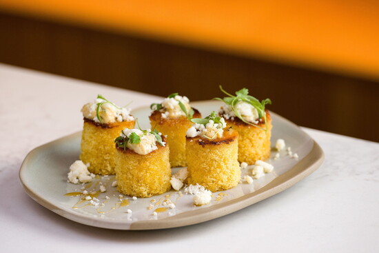 Conroux cornbread muffins are served with habanero-cotija butter, cilantro and a drizzle of Texas honey.