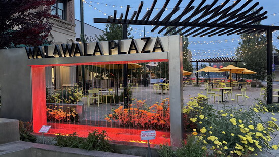 Strings of lights and vibrant blooms frame Walla Walla Plaza, an inviting downtown gathering place ready for conversation, laughter, and fall evenings.