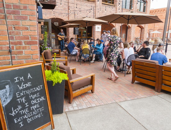 Downtown Walla Walla vibe—live music and laughter fill the air on a sunny afternoon. 